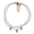 Opal bow knot necklace close up - European pearl accents iridescent shimmer light luxury women jewelry